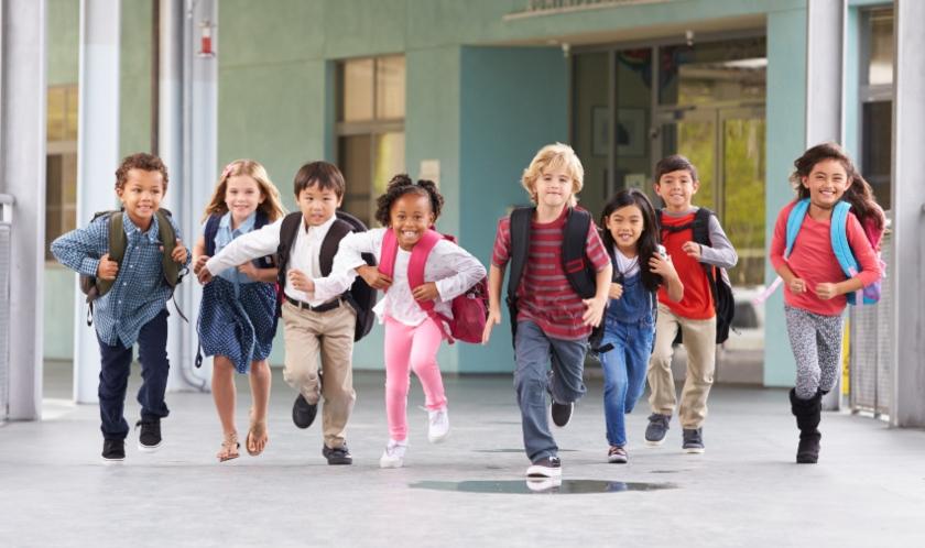 Gruppe von jungen Schuelern rennt durch die Schule - Angst vor der Einschulung ist meist schnell verflogen